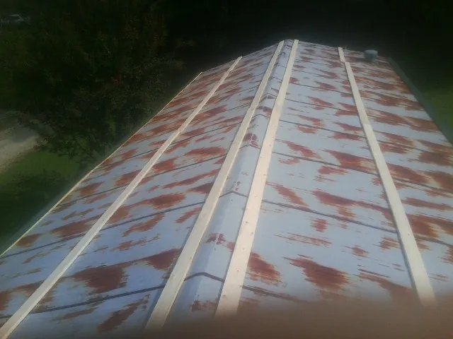 Rusted metal roof panels with new wood purlins before replacement — Storm Damage Roof Repair in Belgium by Roofing Brothers